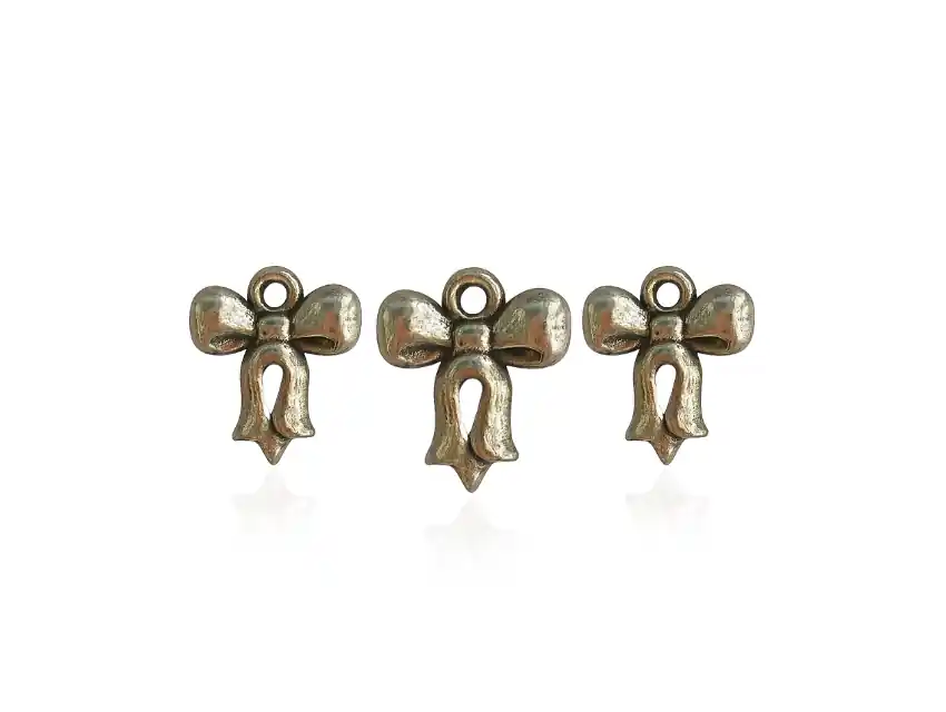 DIJE SIMIL METALICO MOÑO 13MM X 15MM X 50GRS 280UN APROX 